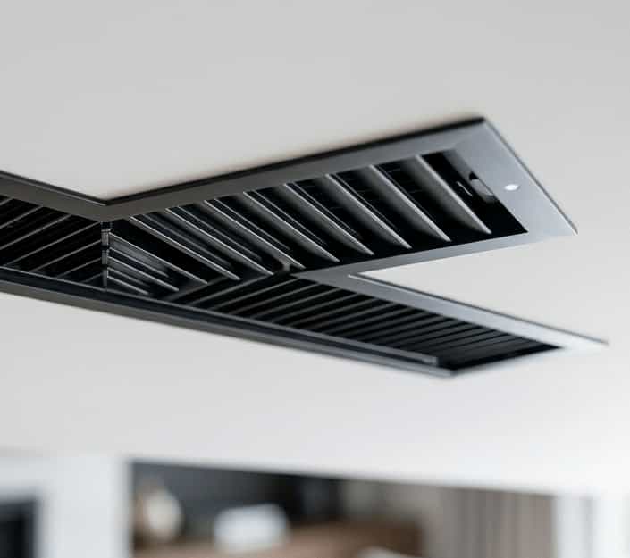 Clean AC vent, thermostat, and modern home cooling details